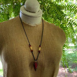 Handmade necklace with arrowhead, carved feather